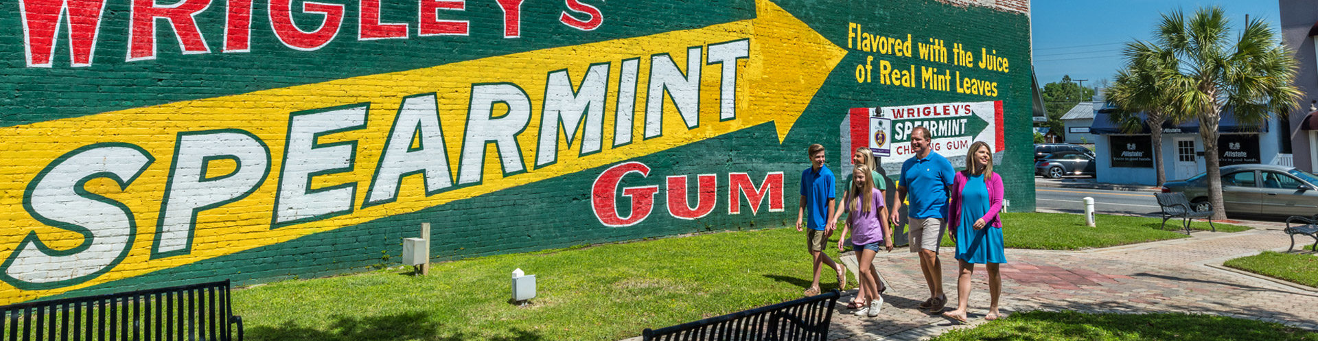 family walking by wrigleys spearmint gum mural in suwannee
